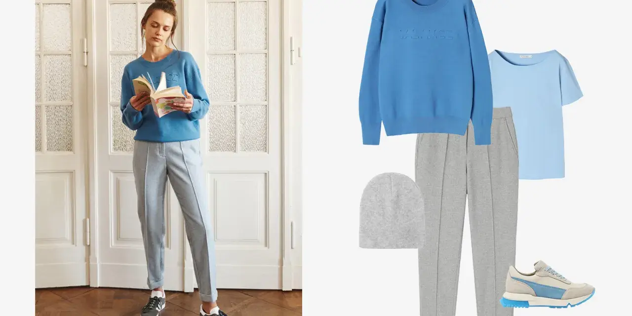 Stylizacja do szarych spodni: błękitny sweter, jasnoniebieska bluzka, szara czapka, szare spodnie dresowe i sneakersy.