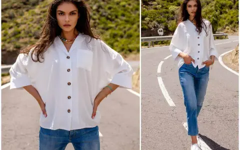 Modelka prezentuje, jak nosić koszule damskie: biała luźna koszula i jeansy. Stylizacja na co dzień.