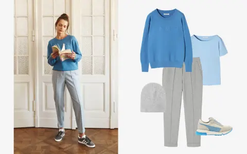 Stylizacja do szarych spodni: błękitny sweter, jasnoniebieska bluzka, szara czapka, szare spodnie dresowe i sneakersy.