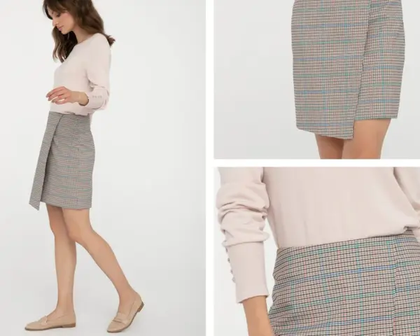 Kratka na spódniczce to ponadczasowy trend. Modelka prezentuje stylową, asymetryczną spódniczkę w kratkę, która z pewnością jest modna.