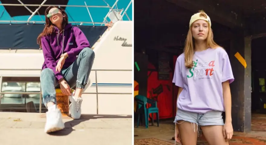 Dwie kobiety w modnych stylizacjach streetwear. Jedna w fioletowej bluzie i jeansach, druga w liliowej koszulce z napisem "Pizza Sport". Polskie marki odzieżowe streetwear w akcji.